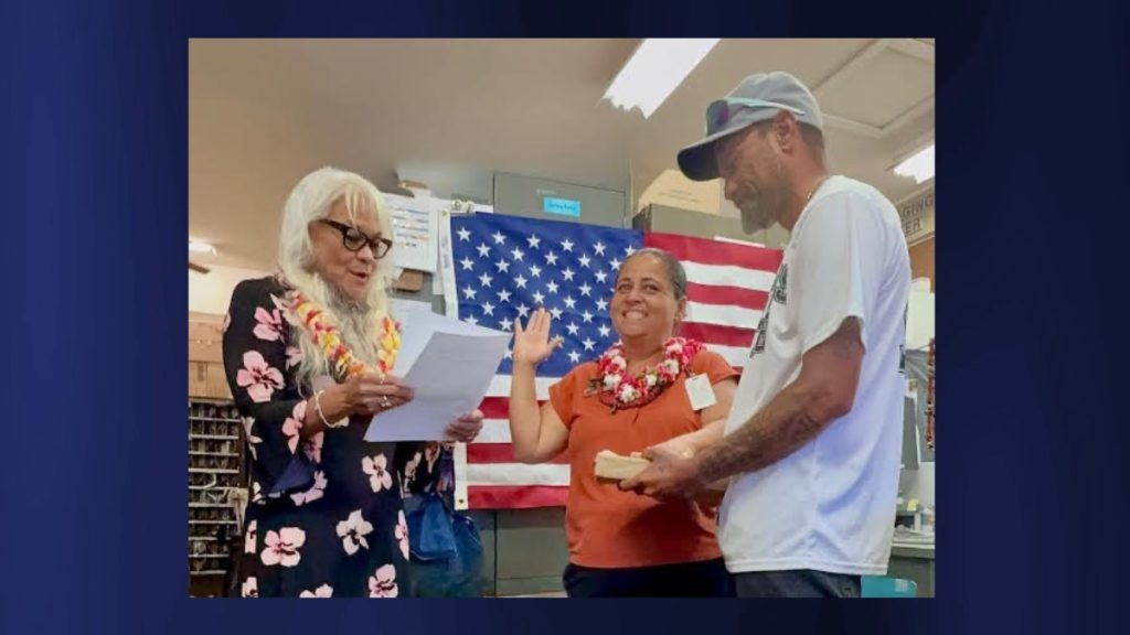 Hawai'i District Manager Eileen Veach is conducting the induction of Anahola Postmaster Keleen Na-o, who stands at the center, with her husband, Kawika Na-o, Sr., by her side. (Photo Credit USPS)