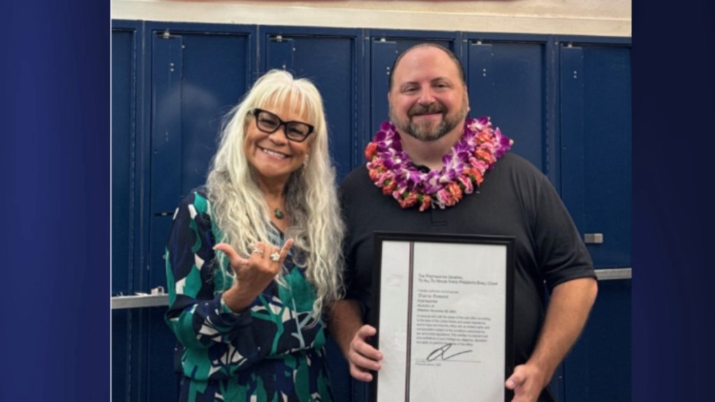 Hawai'i District Manager Eileen Veach poses with Kilauea Postmaster Travis Pement following their meeting in July. (Photo Credit: USPS)