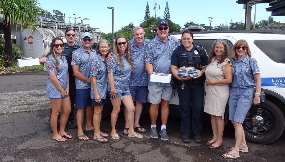 Officer Paterson and Enrique smiled after Tuesday’s North Shore Give visit on Oct. 28, 2025. (Photo Credit: Xiomara Yamileth/ Kaua'i Now)