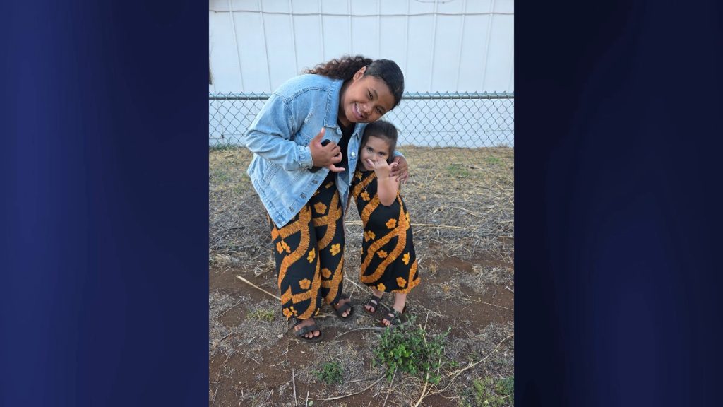 Gialynn 'Gia' Pacheco and her little cousin smile brightly in matching outfits, each giving a shaka for the camera. (Photo Credit: Geraldine Carpenter)