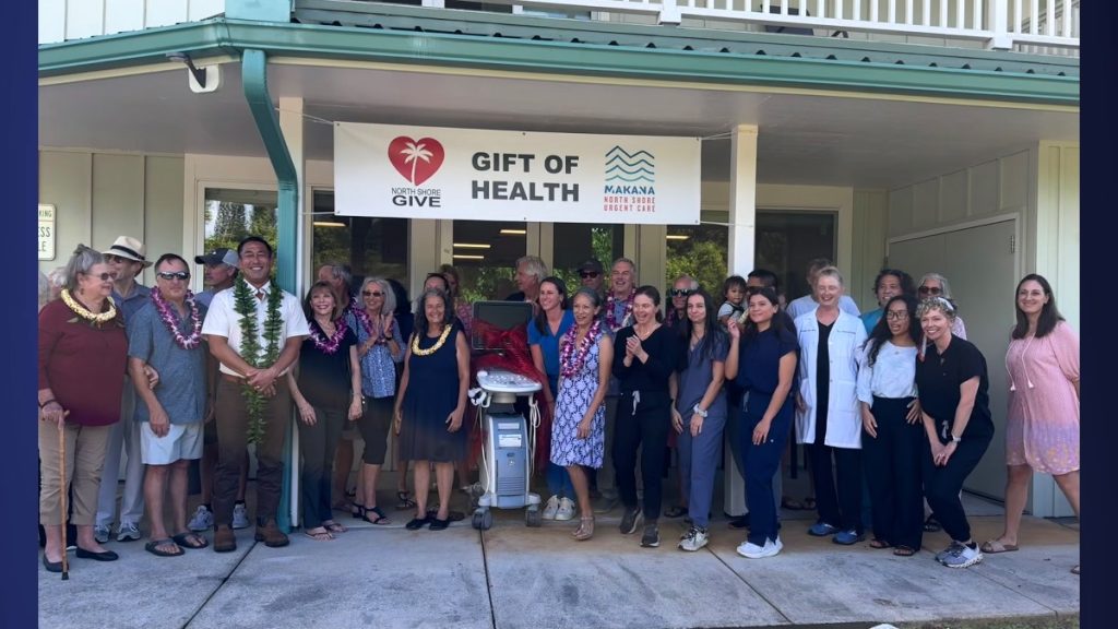 Mayor Kawakami, along with Kaua'i County council members, North Shore Give board members, the architect, physicians, and urgent care staff, pose excitedly next to the new ultrasound machine. (Photo Credit: Xiomara Yamileth/ Kaua'i Now)