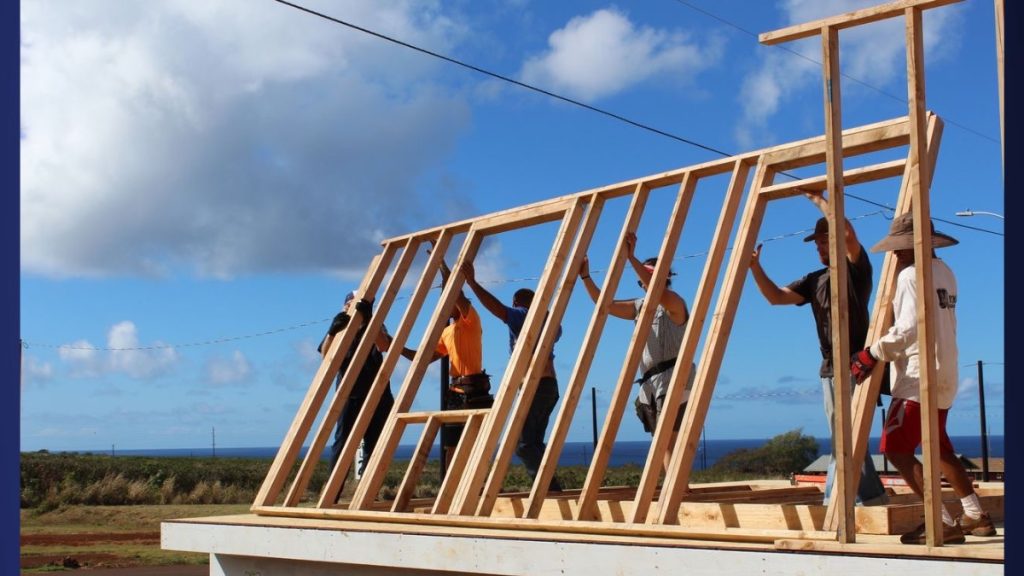 Kauaʻi Habitat construction staff and volunteers raise the first walls on a new home. (Photo credit: Kauaʻi Habitat for Humanity)
