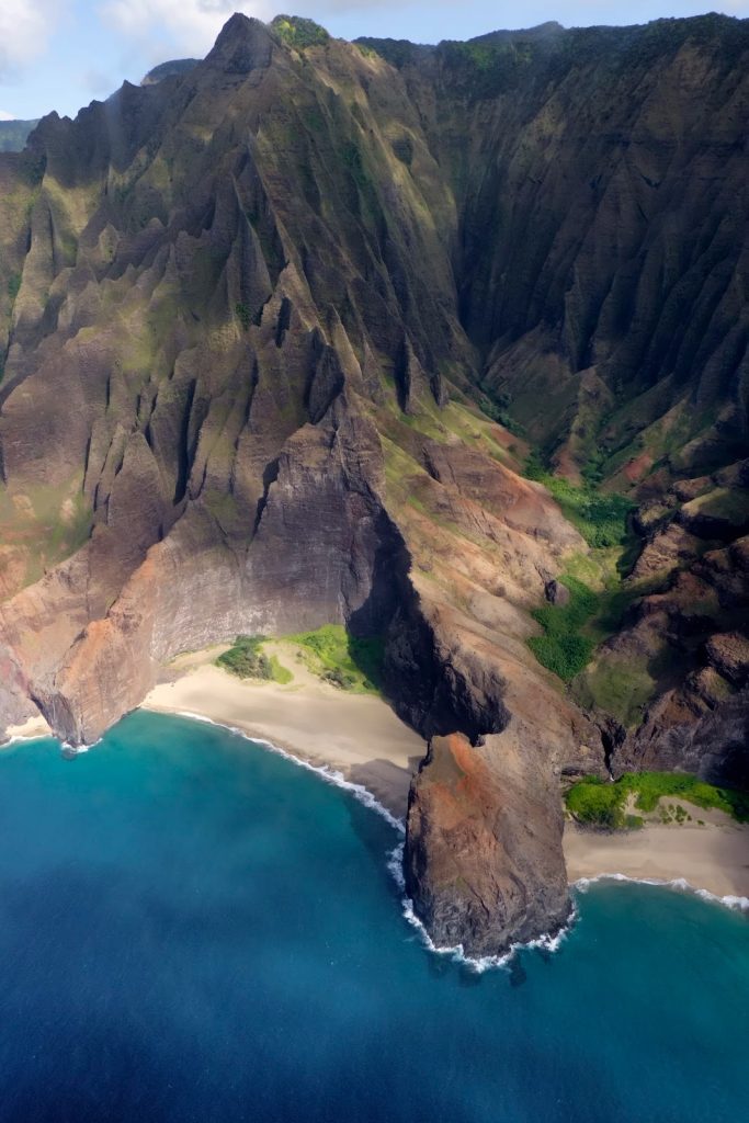 Honopū Valley, known as the “Valley of Echoes,” is a place of deep mystery and reverence. Once home to ali‘i burial sites and tied to legends of the Menehune, its secluded cliffs and windswept arch stand as powerful reminders of the Nāpali Coast’s sacred past.