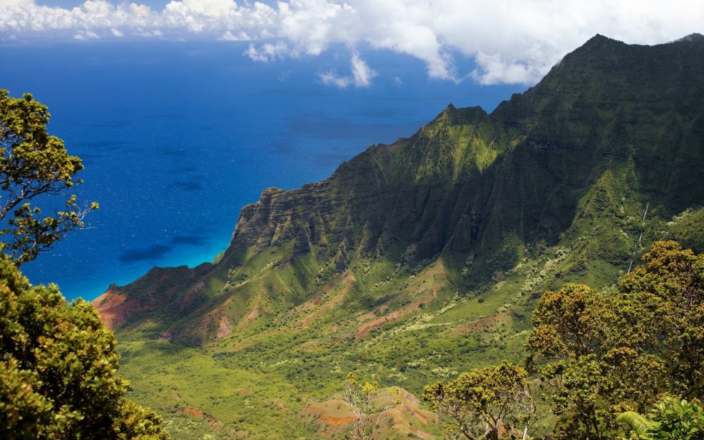 Kalalau Valley, the heart of the Nāpali Coast, was once home to thriving Hawaiian communities who cultivated kalo and fished these abundant shores. Today, its mist-veiled cliffs and sacred beauty remind visitors of the valley’s enduring spirit and the mo‘o guardians said to watch over its land and waters.