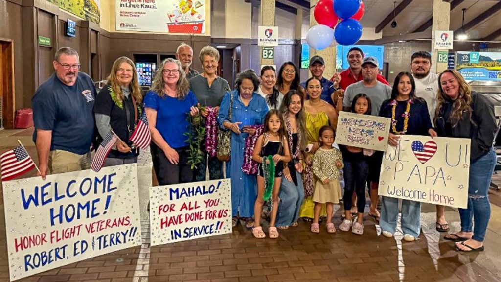 Family and community members assembled at baggage claim B of Līhuʻe Airport on Oct. 8, 2025, to honor and recognize the contributions of three Vietnam veterans. (Photo Credit: Xiomara Yamileth/ Kauaʻi Now) 