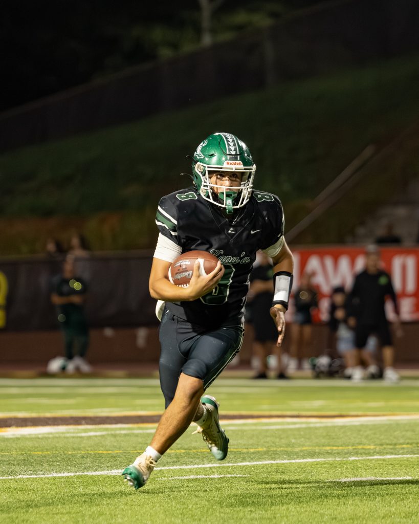 Kapa'a High School quarterback Kaitin Mundon runs for yardage in the Warriors' 13-9 loss in the HHSAA Division I state championship game on Friday at Mililani High School's John Kauinana Stadium. (Kinue Miller/ScoringLive)