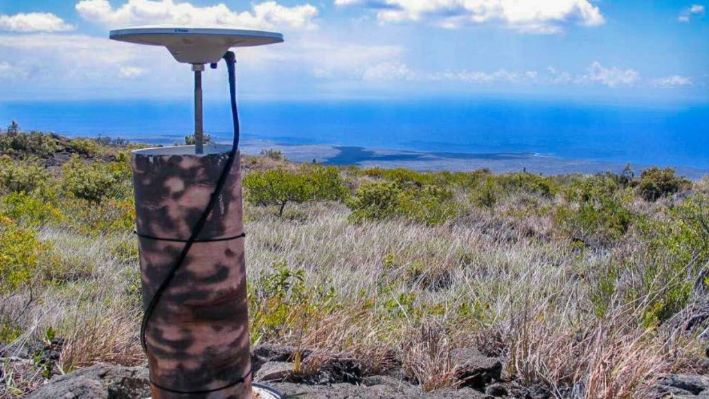 The view from a continuous GPS station on Kīlauea’s south flank, looking over the Hilina and Hōlei Pali to the ocean. This instrument was installed in 1996 to monitor seaward motion of the south flank. (USGS photo by K. Kamibayashi)