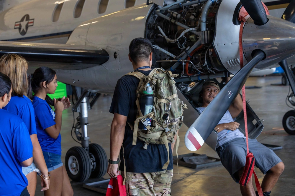 Students from Waimea Canyon Middle School and their chaperone speak with an aircraft maintainer during a workforce awareness event for local students highlighting the various careers available on Pacific Missile Range Facility, Barking Sands on March 6, 2026. ( US Navy Photo by Mass Communication Specialist 1st Class Louis Lea)