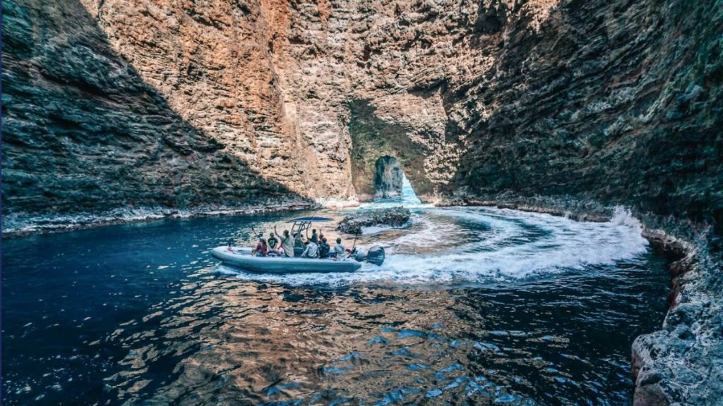 A Blue Dolphin Kauaʻi raft navigates inside one of the Nāpali Coast's sea caves that were carved over millennia by the relentless force of the Pacific. (Photo Credit: Ilana Maxwell)