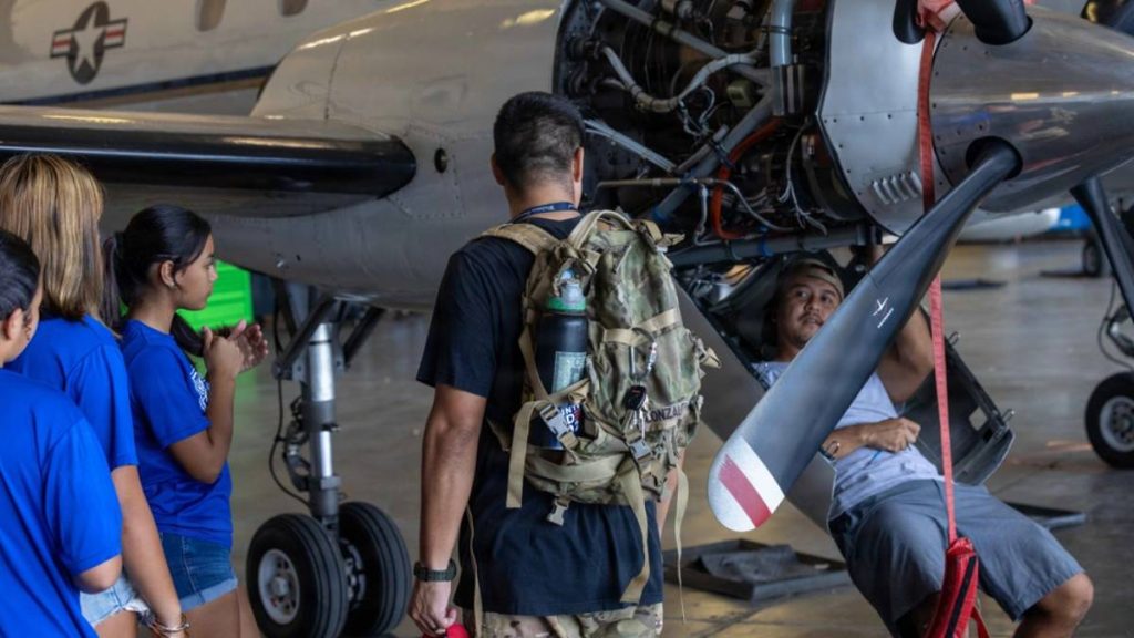 Students from Waimea Canyon Middle School and their chaperone speak with an aircraft maintainer during a workforce awareness event for local students highlighting the various careers available on Pacific Missile Range Facility, Barking Sands on March 6, 2026. ( US Navy Photo by Mass Communication Specialist 1st Class Louis Lea)