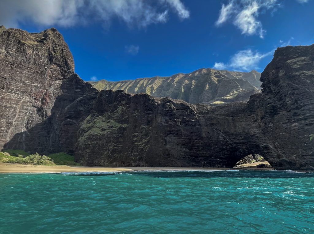 Accessible only by sea or a grueling trail, this secluded Nāpali Coast beach sits beneath some of the most ancient and storied cliffs in all of Hawaiʻi. (Photo Credit: Ilana Maxwell)