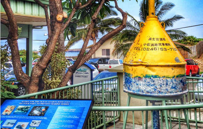 A buoy from Onahama Bay, the port serving Iwaki City, Japan, is on display in ʻEleʻele after washing up near Kauai from the 2011 Japan tsunami. (Photo Credit: Kauaʻi County)