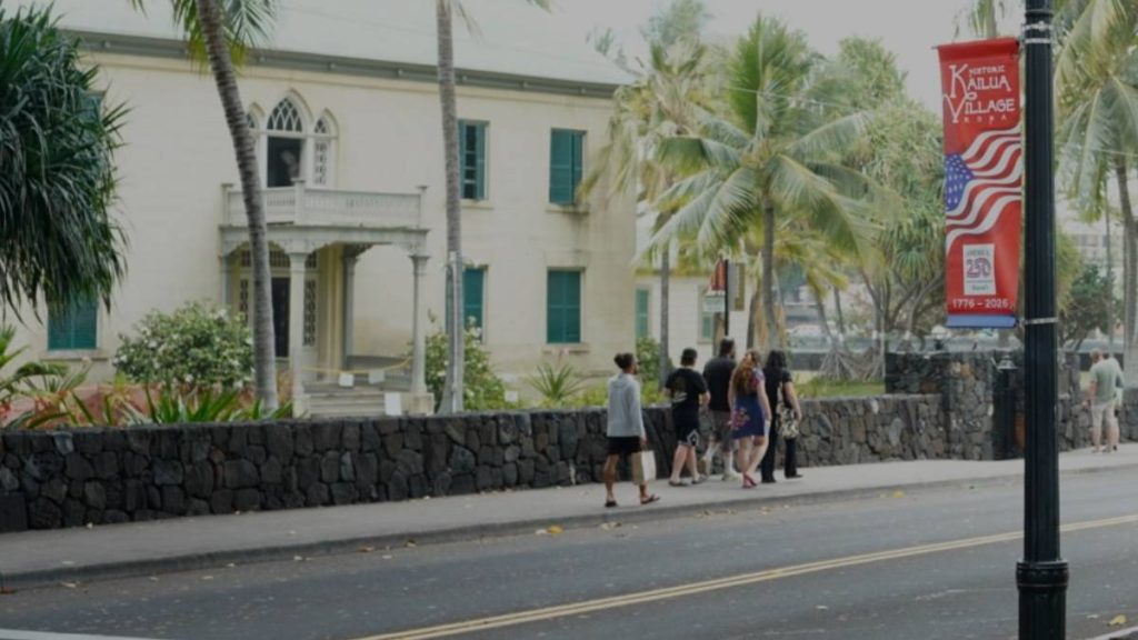 Banners highlighting the 250th anniversary of the founding of the United States of America are displayed on streets along Ali‘i Drive in front of Hulihe‘e Palace, the summer home to the kings and queens of the former Hawaiian Monarchy. (Tiffany DeMasters/Big Island Now 